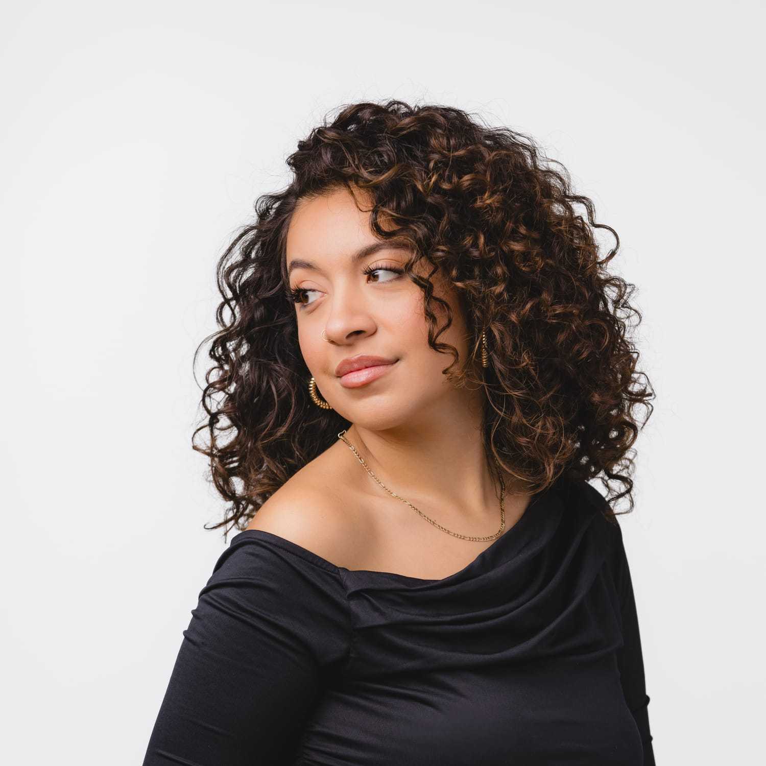 Portrait of Cass, a professional stylist at Bobby Cooper, showcasing their expertise and style.