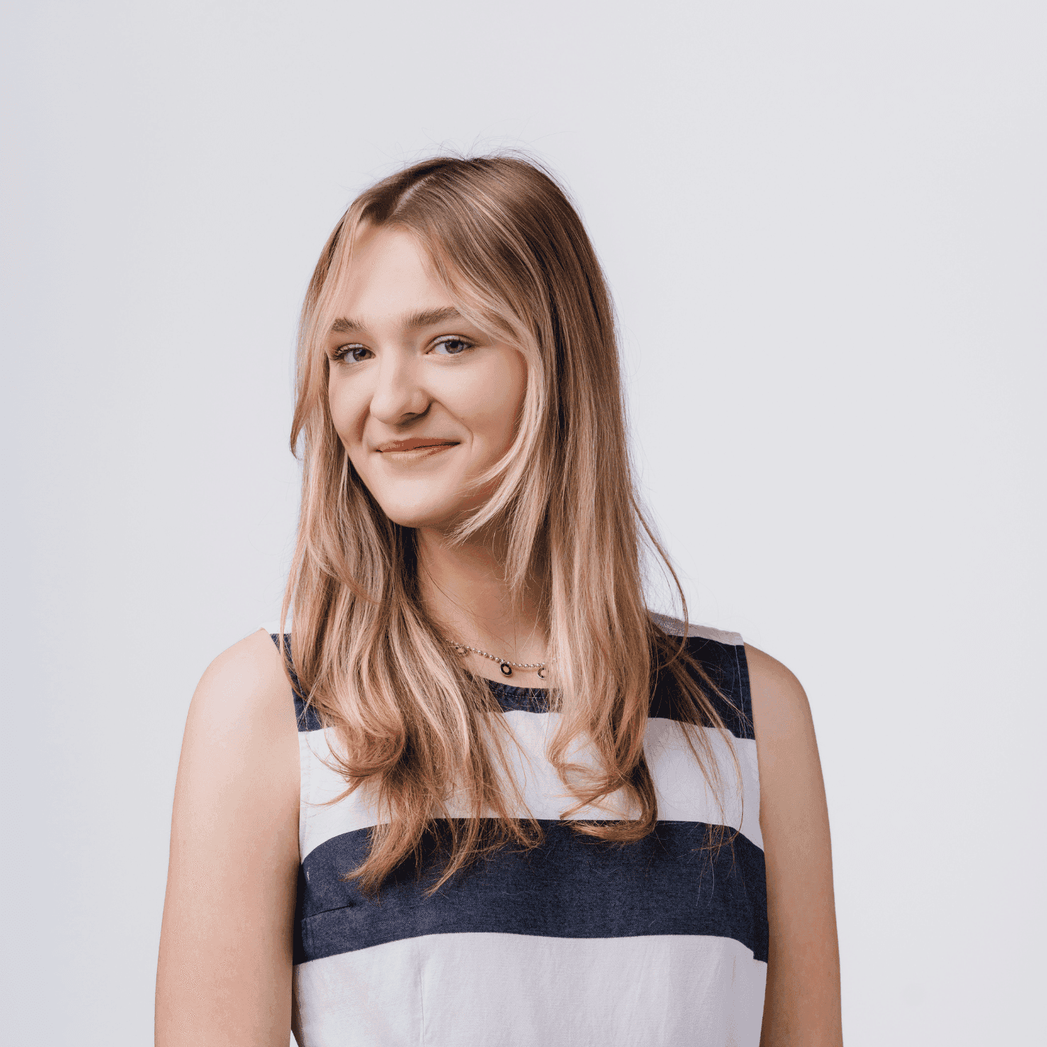 Portrait of Kya, a professional stylist at Bobby Cooper, showcasing their expertise and style.