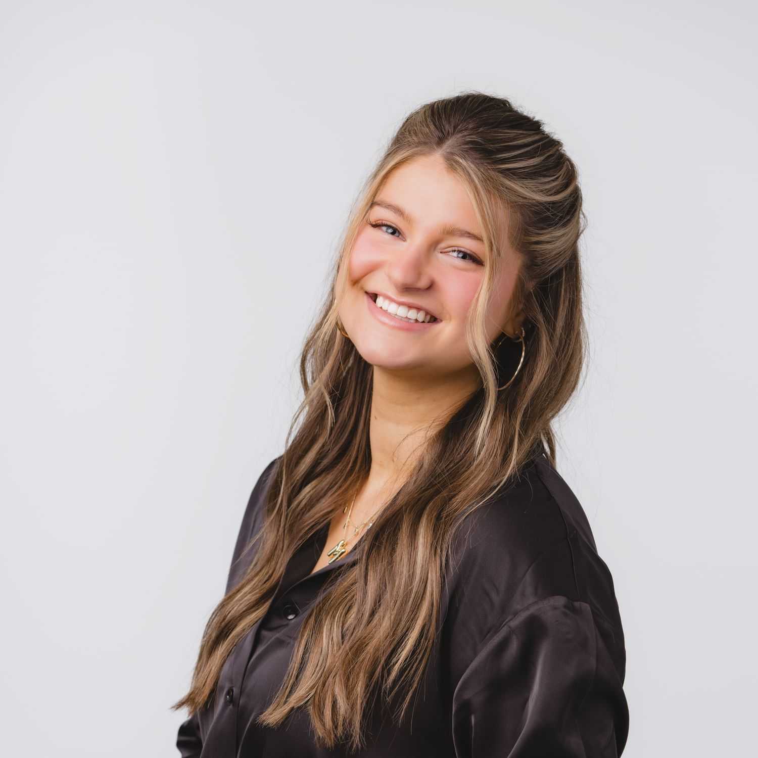 Portrait of Maddi Christy, a professional stylist at Bobby Cooper, showcasing their expertise and style.