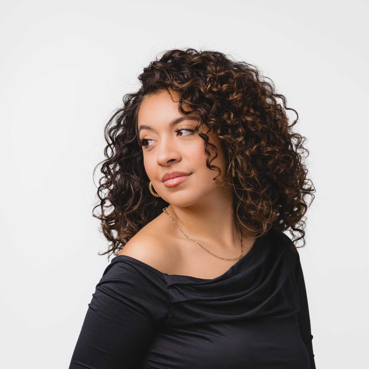 Portrait of Cass, a professional stylist at Bobby Cooper, showcasing their expertise and style.